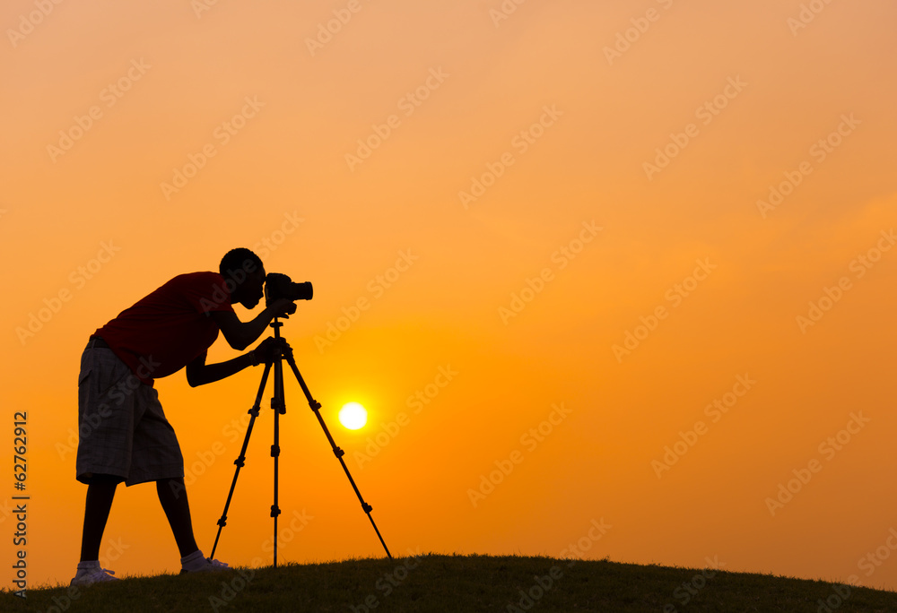 Young Photographer At Sunset