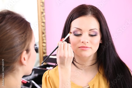 Young woman stylist doing m...