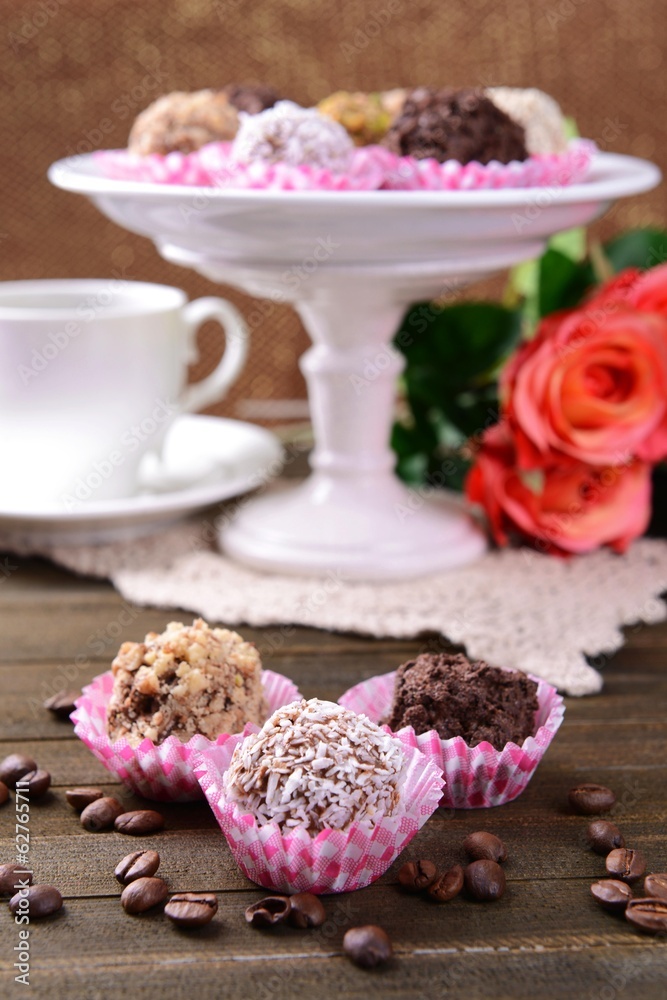 Set of chocolate candies on table on brown background