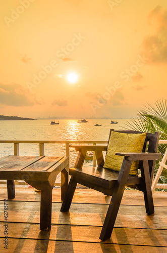 Wood chair sunset on the beach © siraphol