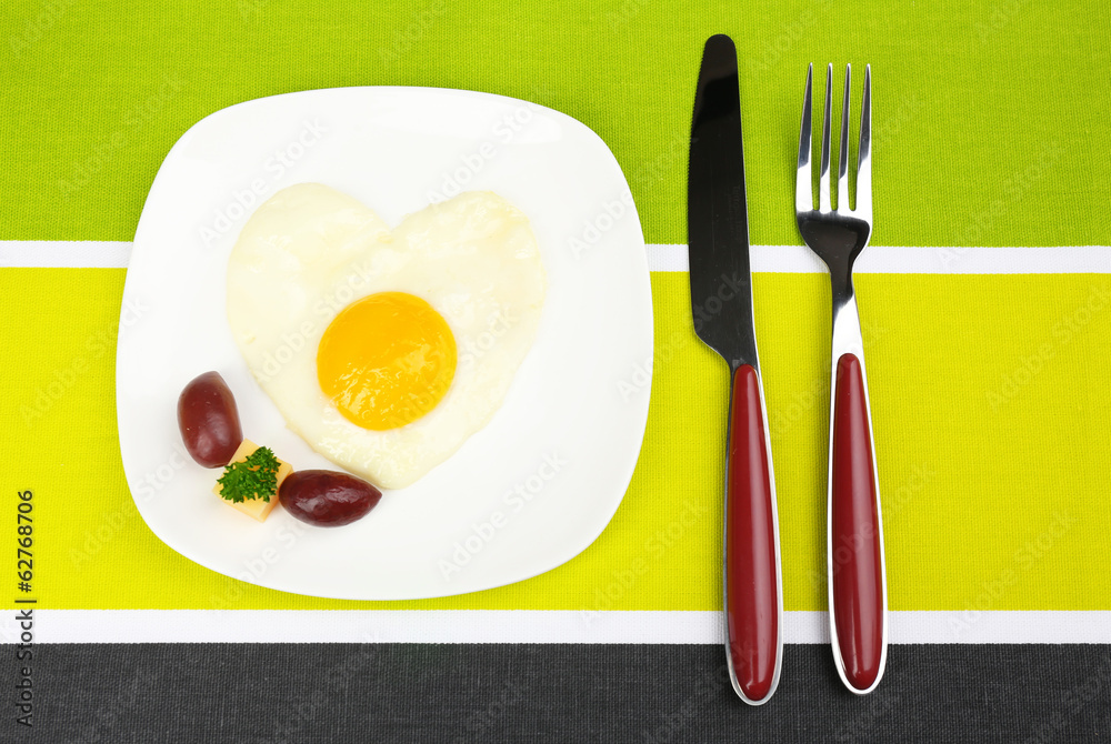 Scrambled eggs with bread on plate, on color napkin Scrambled eggs with bread on plate, on color napkin