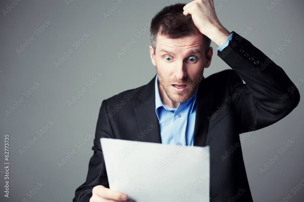 terrified businessman reads contract terrified businessman reads contract