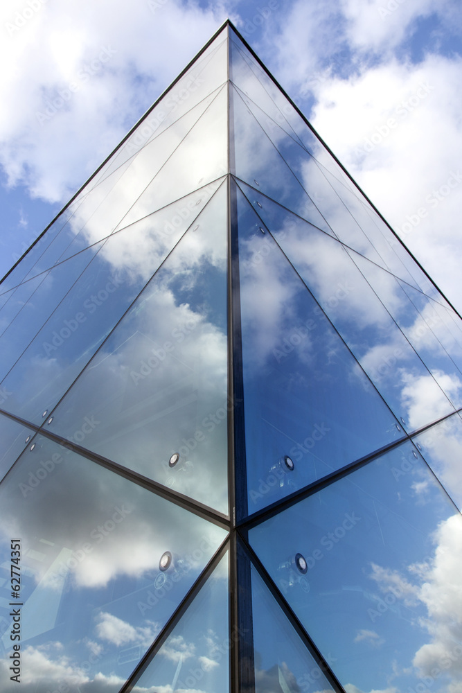 reflexions of clouds and  sky in facade of modern building