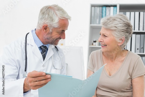 Male doctor and senior patient with reports © WavebreakMediaMicro