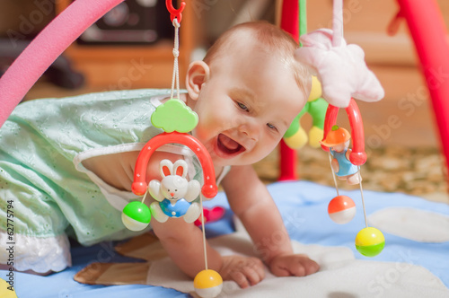 little baby playing with toys at home