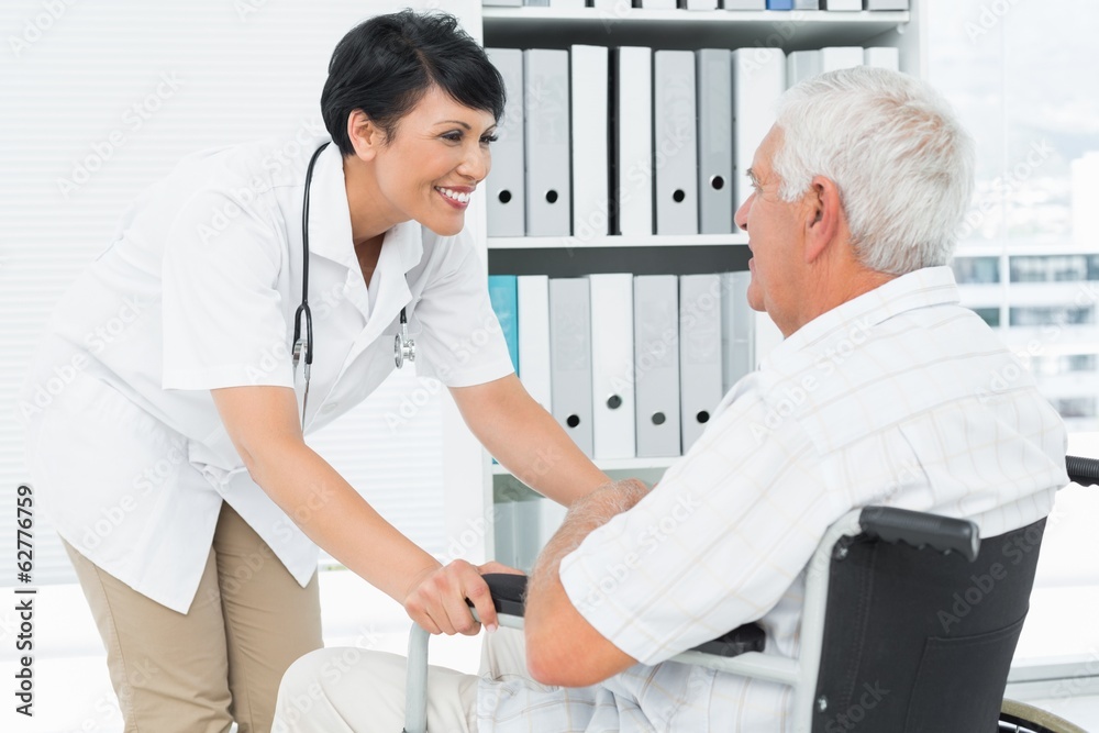Fototapeta premium Female doctor talking to a senior patient in wheelchair