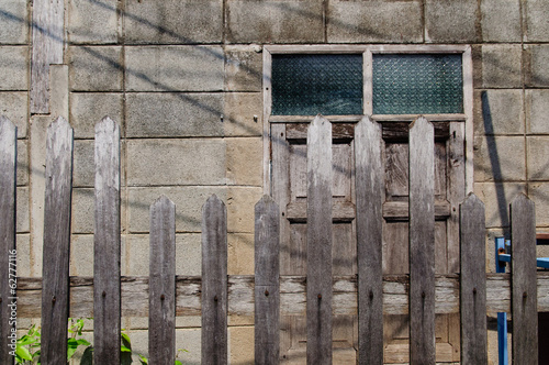 Old rural house with window and wooden fence