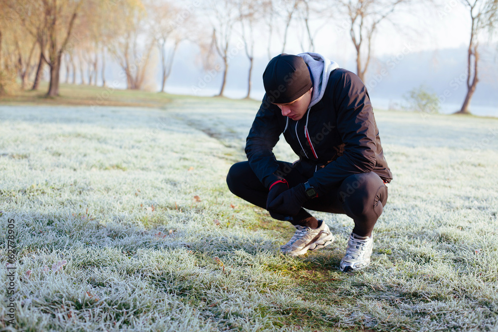 Tired atlete resting after winter run at morning Tired atlete resting after winter run at morning