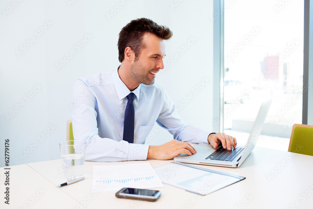 Man working on laptop in the office Man working on laptop in the office