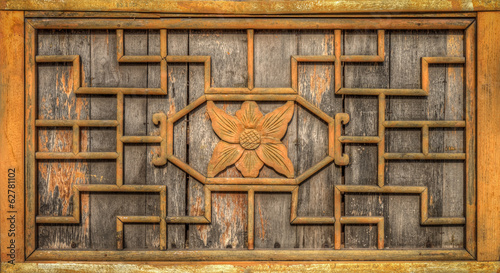 The ancient wooden wall frame is decorated with carving wood