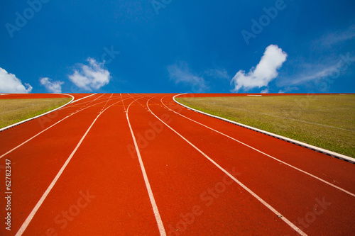 Running track over blue sky and clouds