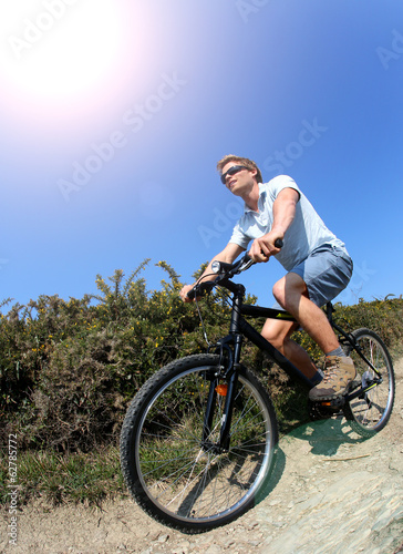 Man riding bike on a country pathway