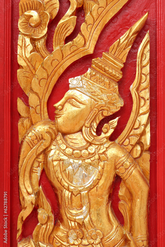 thai style golden carving art on the wall temple