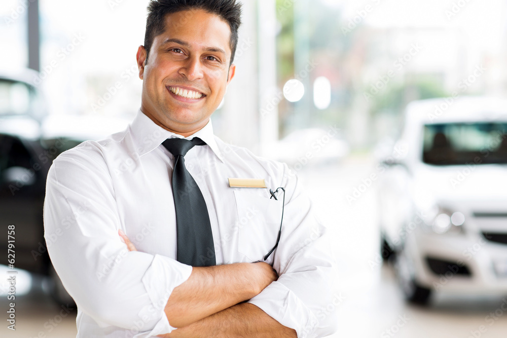 indian vehicle salesman with arms crossed