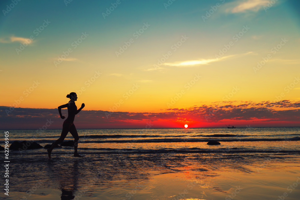 Silhouette of female runing  along the sea coast