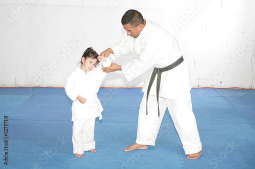 Black belt Karate teaching a little girl