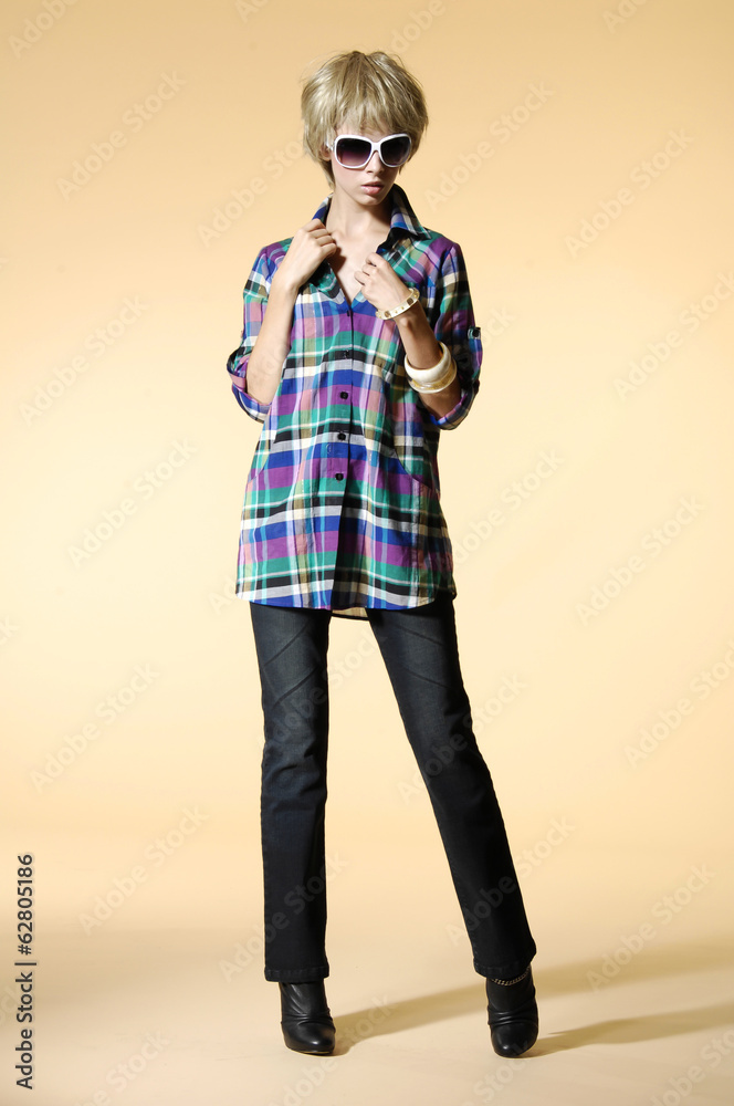 young fashion blond model in sunglasses posing in studio young fashion blond model in sunglasses posing in studio