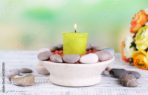Composition with spa stones, candle and flowers