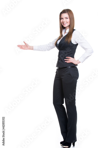 Happy woman in gray suit pointing at something.