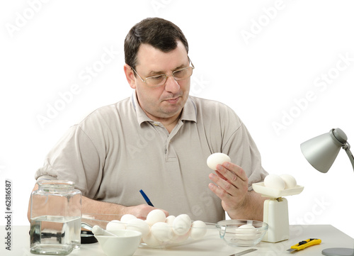 Phytocontrol engineer carefully analyzes eggs photo