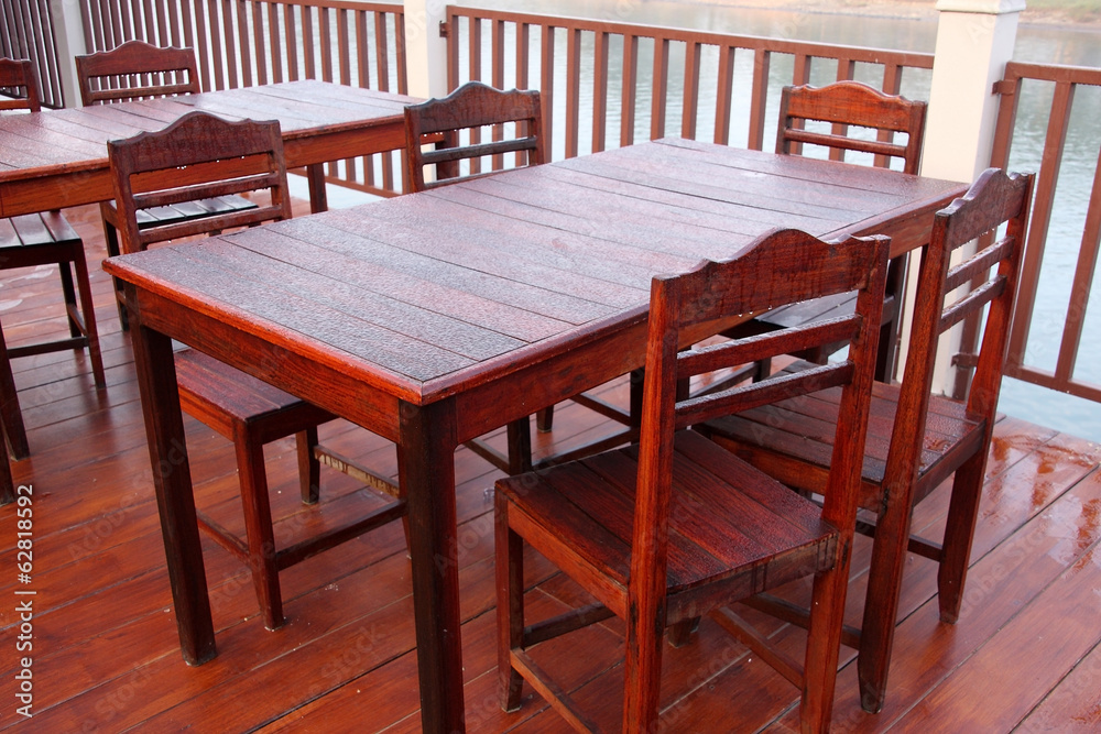 Wooden table and chairs covered in dew drops