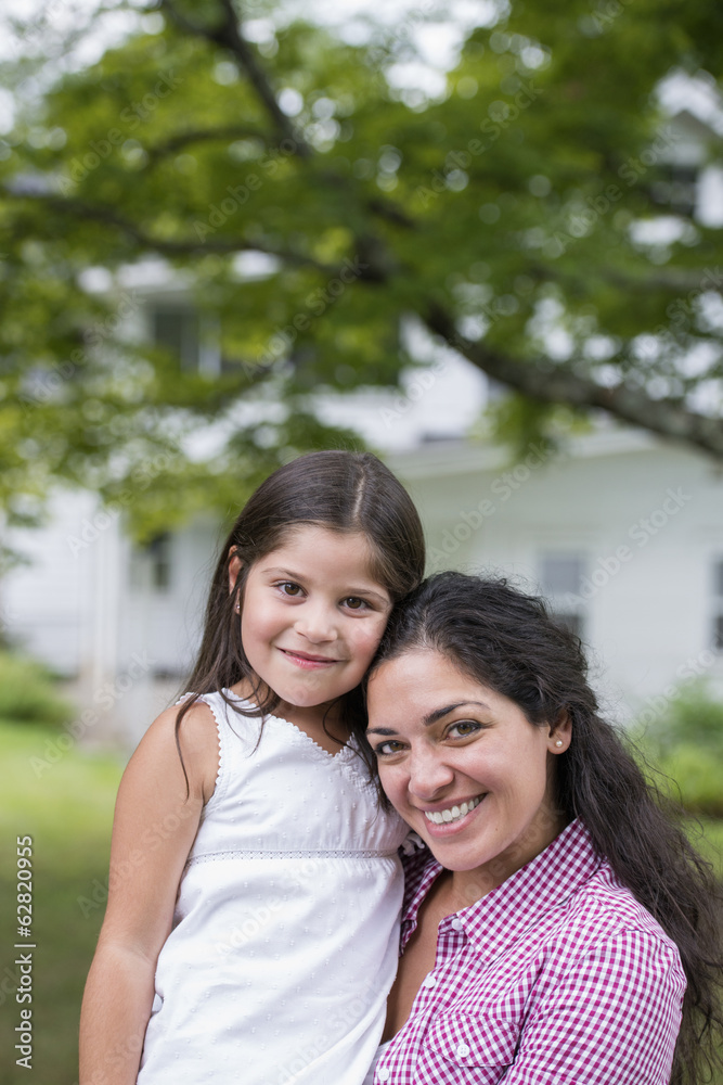 A mother and daughter in a country garden. A mother and daughter in a country garden.