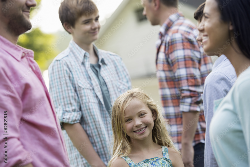 A group of people, adults and teenagers at a summer party. A group of people, adults and teenagers at a summer party.