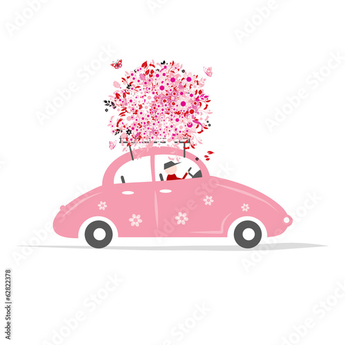 Man driving pink car with floral bouquet on roof