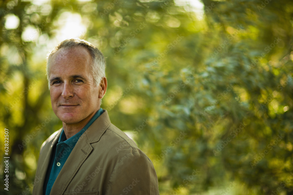 A mature man wearing a green shirt, in woodland. A mature man wearing a green shirt, in woodland.