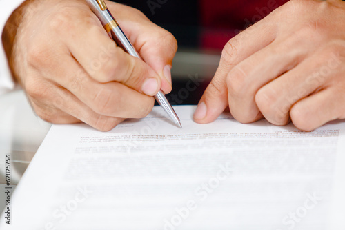 Close-up of business man signing a contract