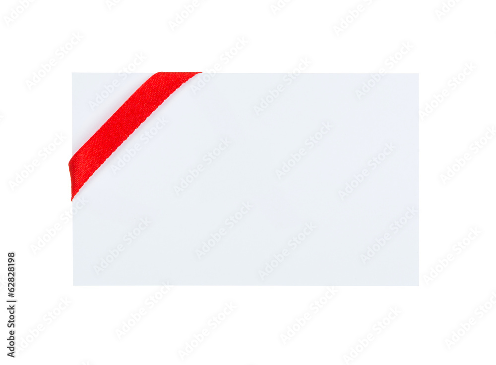 Close up of card with red ribbon bow on white background Close up of card with red ribbon bow on white background