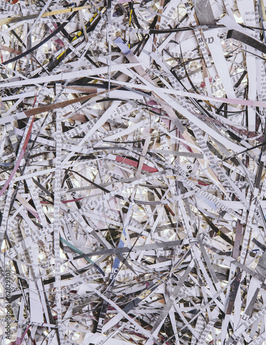 A pile of long thin shredded pieces of printed newspapers.