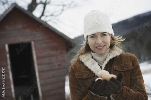 An organic farm in upstate New York, in winter. A woman holding a clutch of hen's eggs in her hands. photo