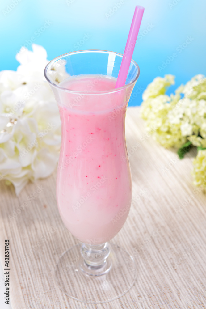 Milk shake on table on light blue background Milk shake on table on light blue background