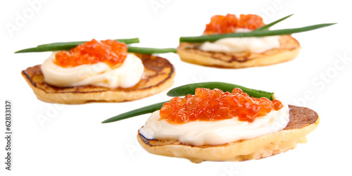 Pancakes with red caviar isolated on white