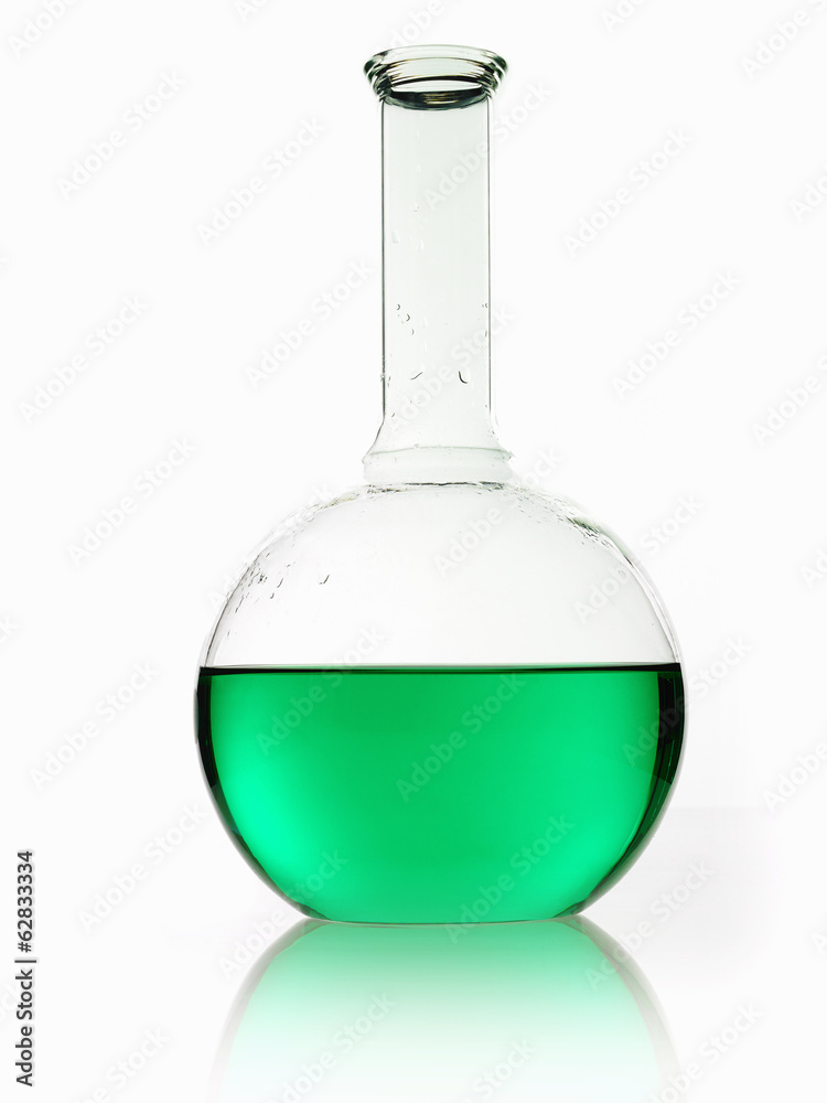 A rounded glass scientific chemical flask with a long funnel neck, holding green liquid. A rounded glass scientific chemical flask with a long funnel neck, holding green liquid.