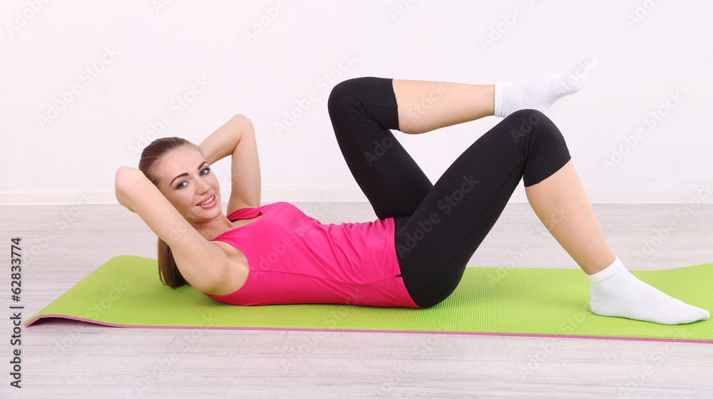 Young beautiful fitness girl exercising in gym Young beautiful fitness girl exercising in gym