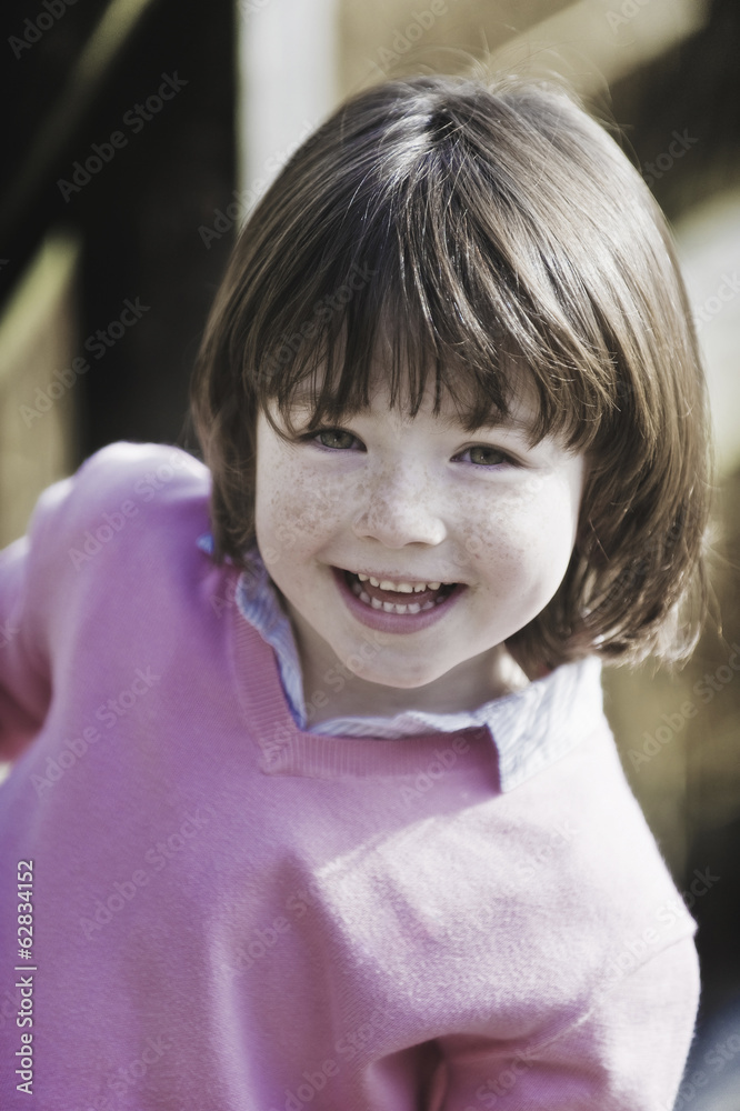 Young boy with brown hair and freckles, wearing pink sweater. Young boy with brown hair and freckles, wearing pink sweater.