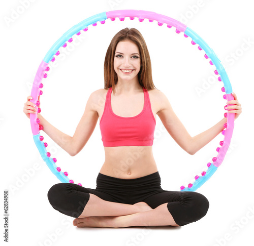 Woman doing exercises with hula hoop isolated on white © Africa Studio