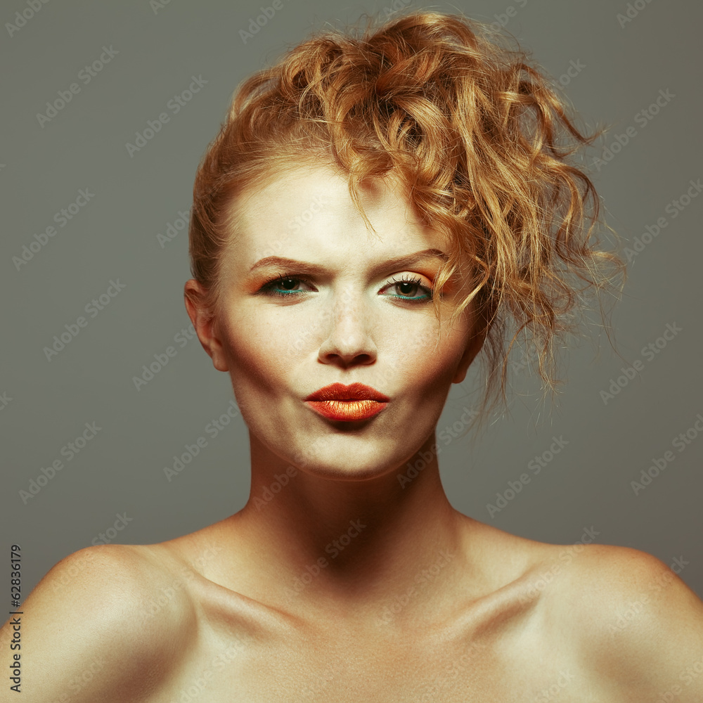 Fototapeta Model with red (ginger) curly hair. Freckles on face. Close up