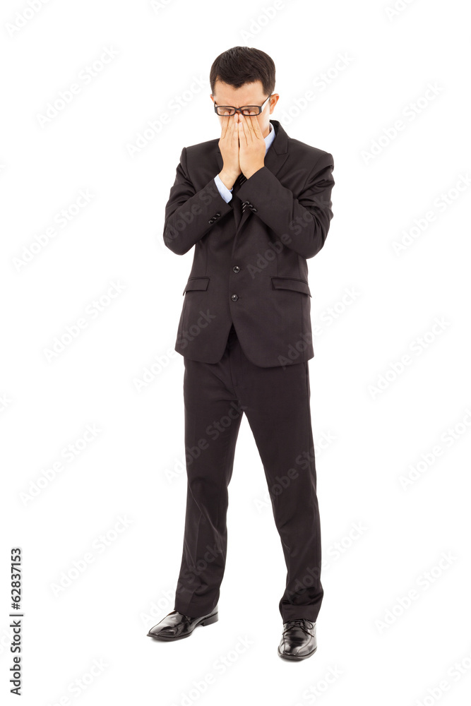 tired young businessman rubbing his eyes tired young businessman rubbing his eyes
