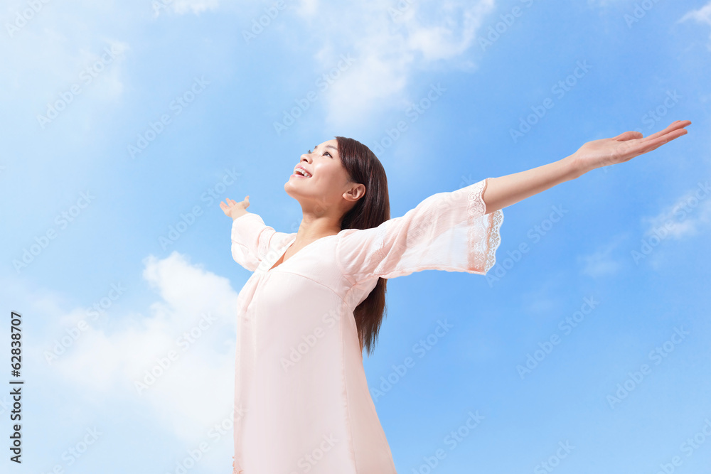 Beautiful woman breathing fresh air with raised arms Beautiful woman breathing fresh air with raised arms