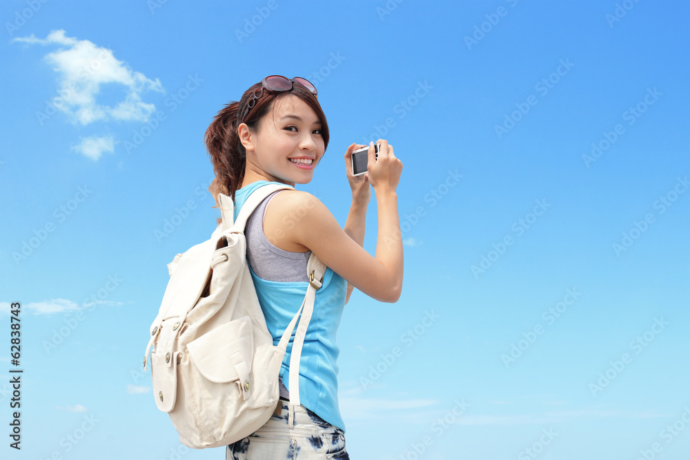 Happy woman traveler photo by camera