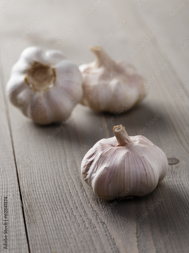 whole garlic on wood table whole garlic on wood table