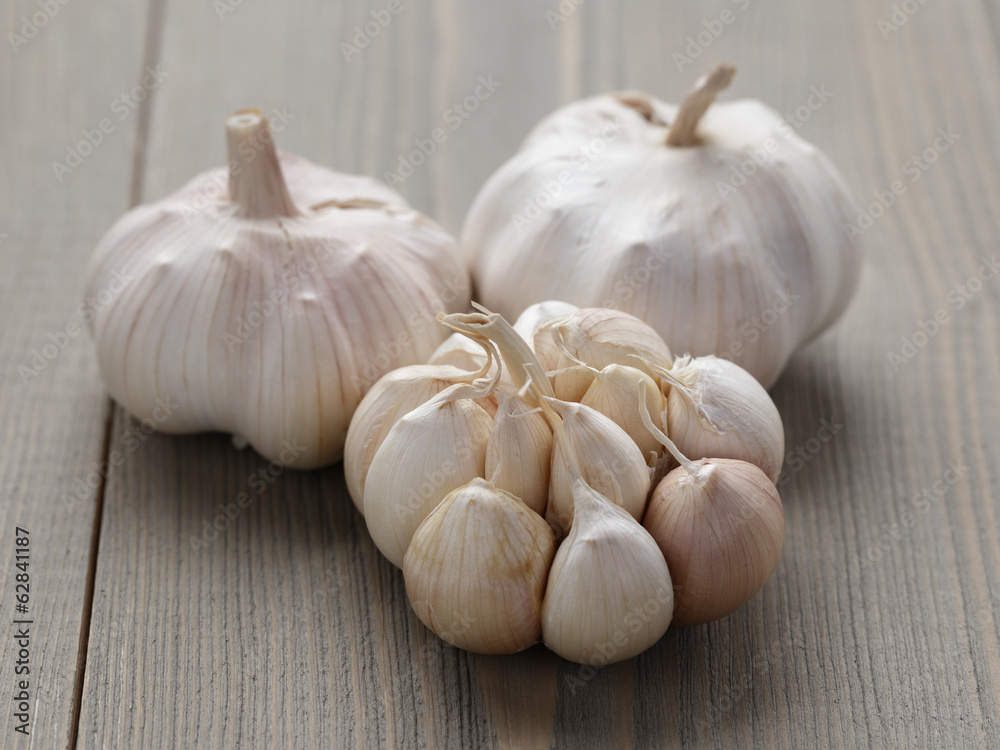 whole garlic on wood table whole garlic on wood table