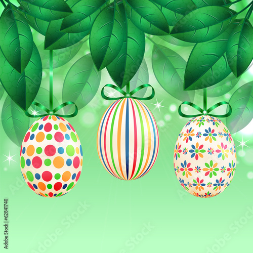 Easter eggs with colorful patterns on a background of spring fol