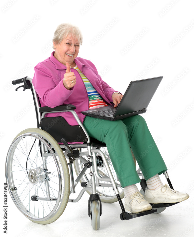 female senior in wheelchair using a computer female senior in wheelchair using a computer