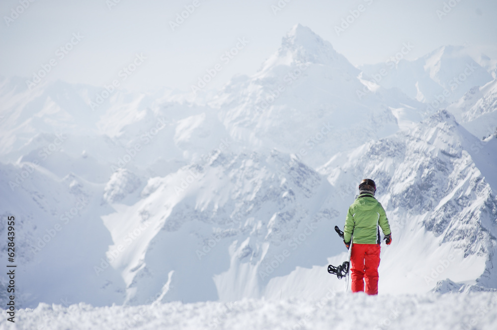 Female snowboarder at the mountains