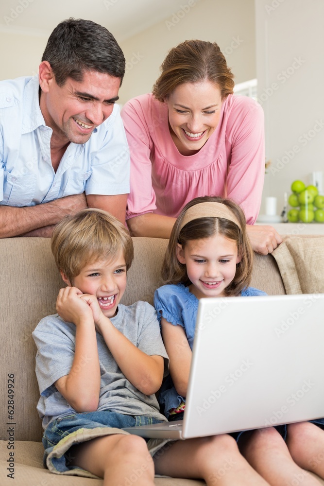 Parents watching children using laptop Parents watching children using laptop