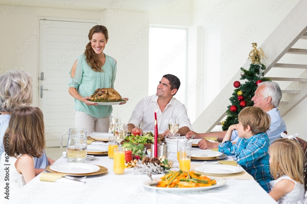 Mother serving Christmas meal to family